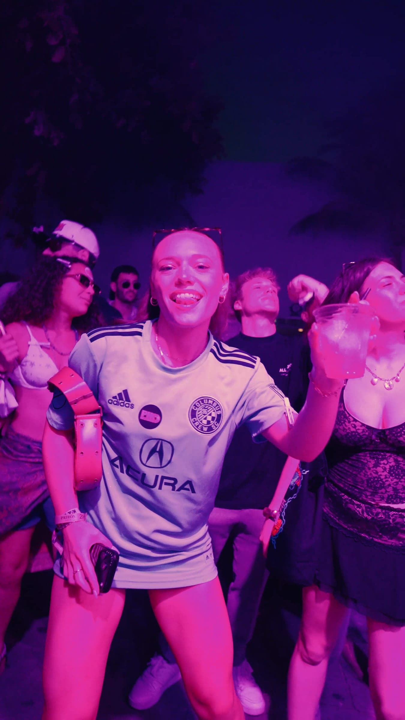 A dancer in a football jersey laughing on the dance floor